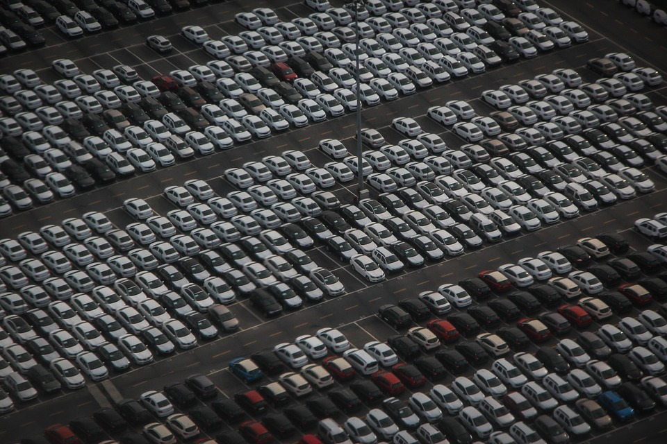 Multiple rows of demo vehicles at a dealership